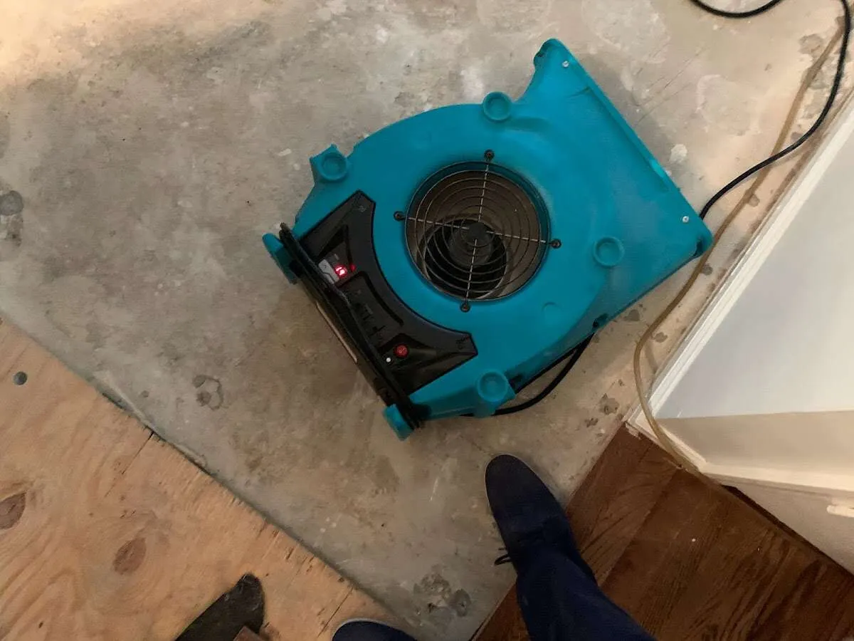 Air mover drying subfloor during Commercial Water Damage Restoration in Omaha